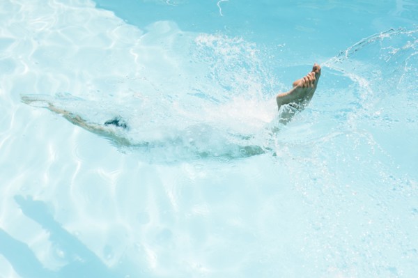 Caucasian woman diving in swimming pool
