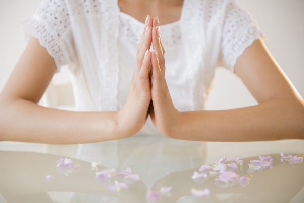 Hispanic woman meditating at table