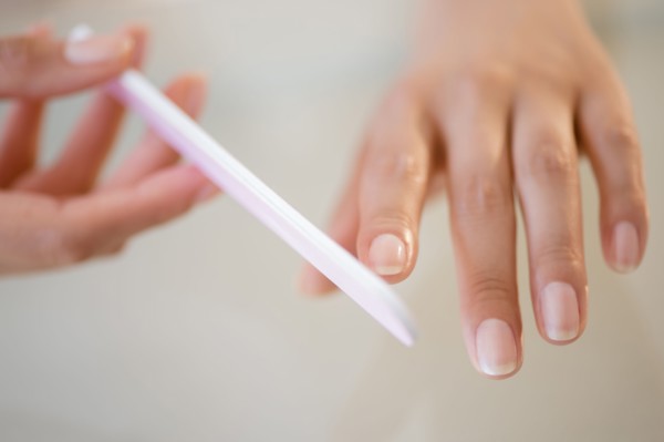Close up of Hispanic woman filing her nails