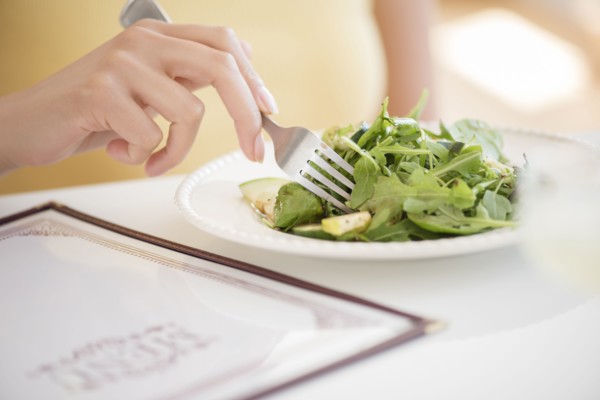 Hispanic woman eating salad