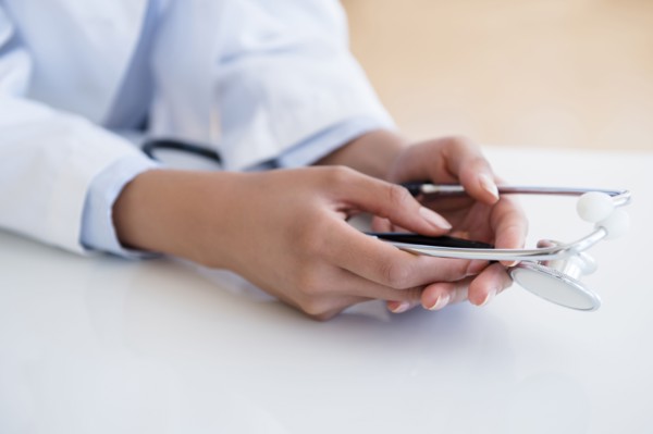 Hispanic doctor holding stethoscope