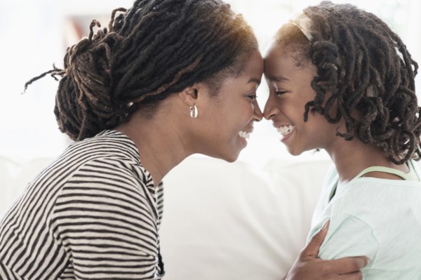 Black mother and daughter touching noses