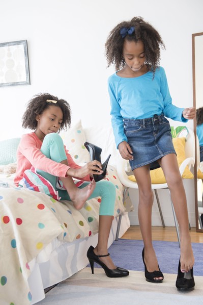 Mixed race sisters playing dress up