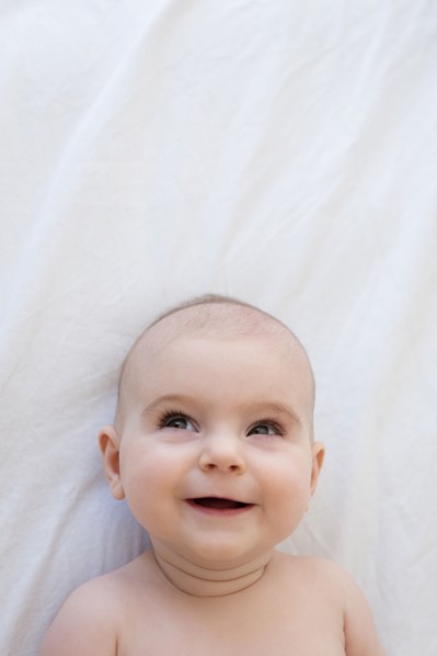 Caucasian baby girl laying on blanket