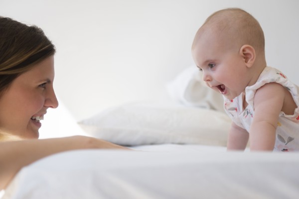 Caucasian mother and baby daughter playing