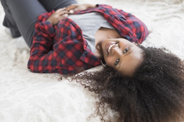 Black woman laying on bed