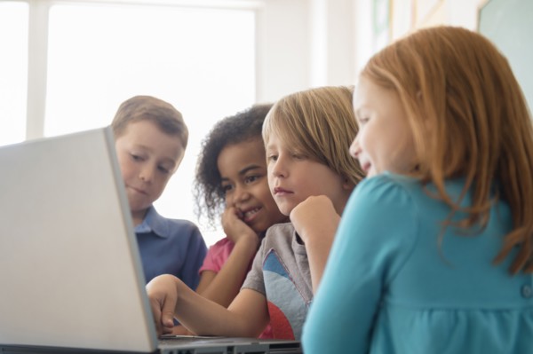 Students using laptop in classroom