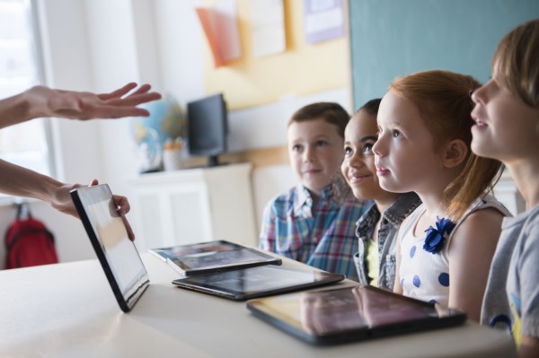 Teacher demonstrating digital tablet for students