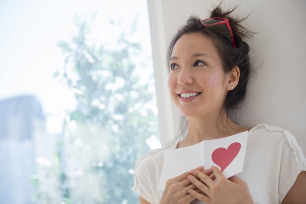 Mixed race woman holding Valentine card