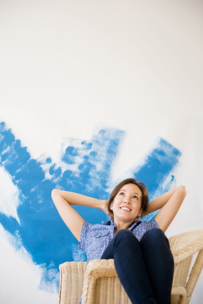 Mixed race woman daydreaming in new home