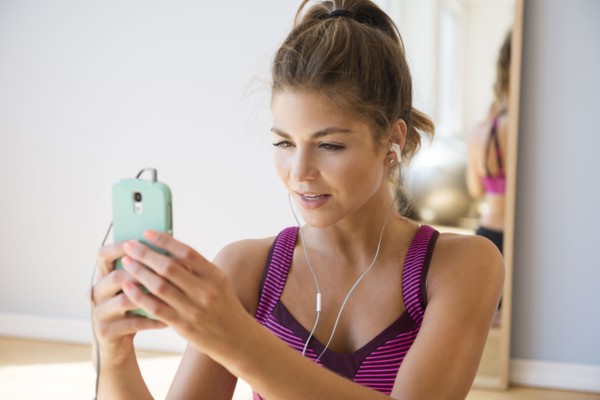Mixed race woman using cell phone