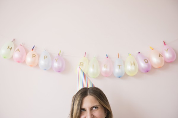Caucasian woman wearing party hat at birthday