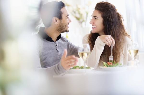 Smiling couple eating at table