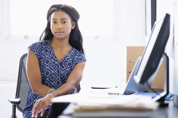 Mixed race businesswoman sitting at desk