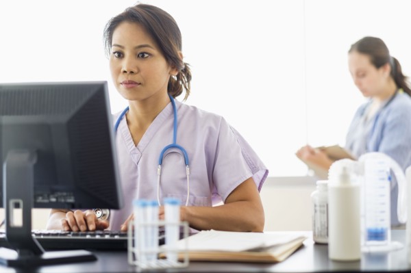 Nurse using computer in hospital