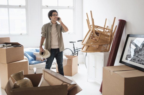 Mixed race man unpacking in new home