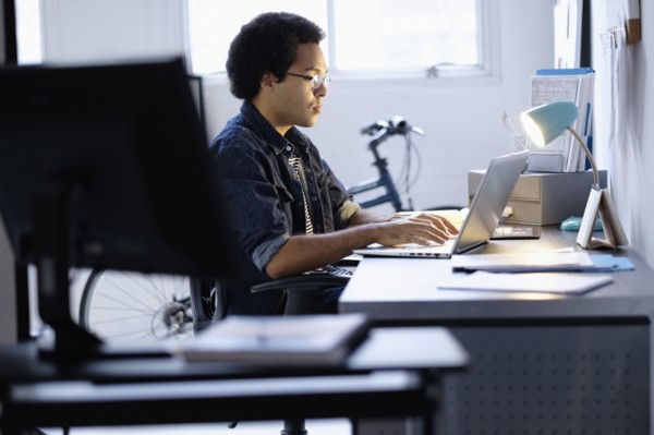 Mixed race businessman working in office