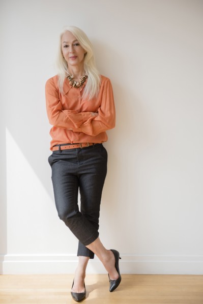 Caucasian businesswoman standing with arms crossed