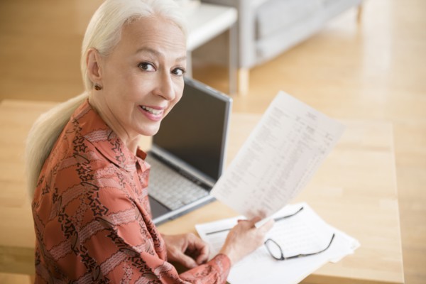 Caucasian woman paying bills on laptop