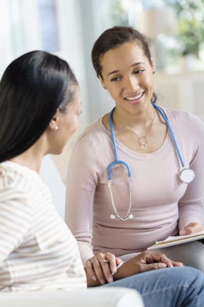 Doctor comforting patient in living room