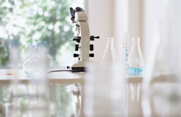Microscope and beakers in laboratory