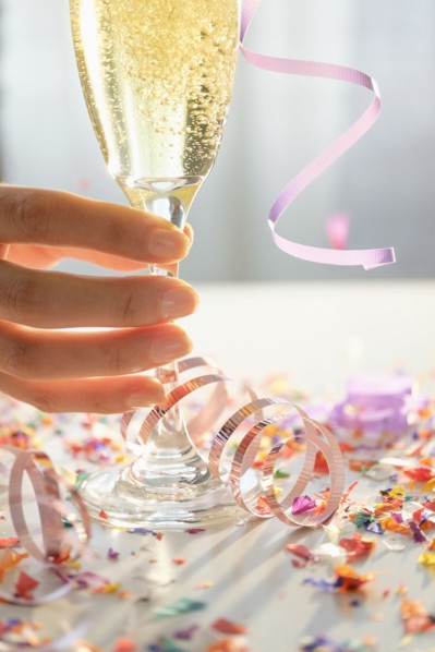 Hispanic woman holding glass of champagne