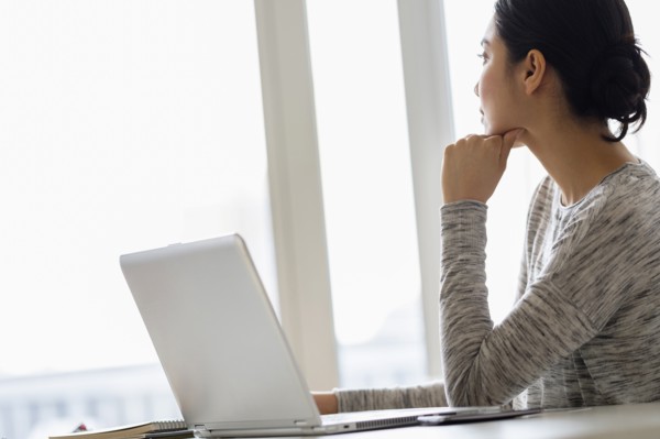 Hispanic woman sitting at laptop