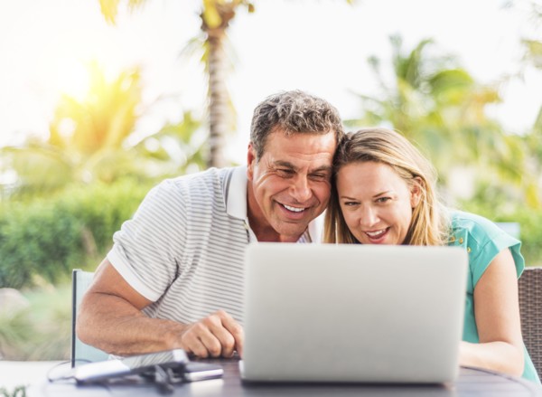 Caucasian couple using laptop outdoors