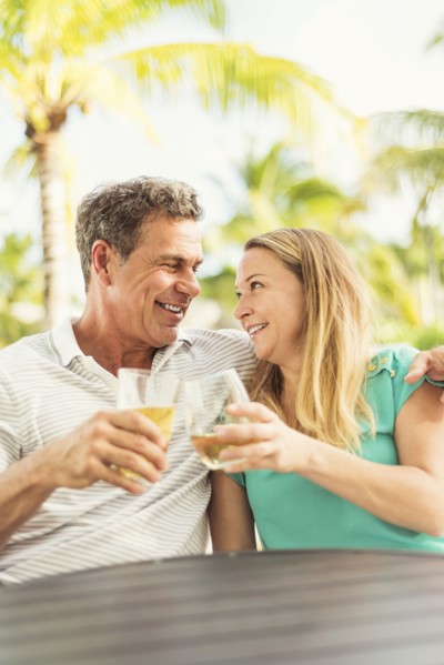 Caucasian couple toasting with wine outdoors