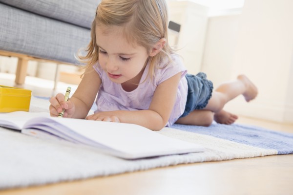 Caucasian girl doodling on floor