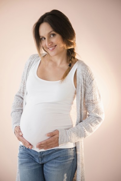 Pregnant Caucasian woman holding her belly