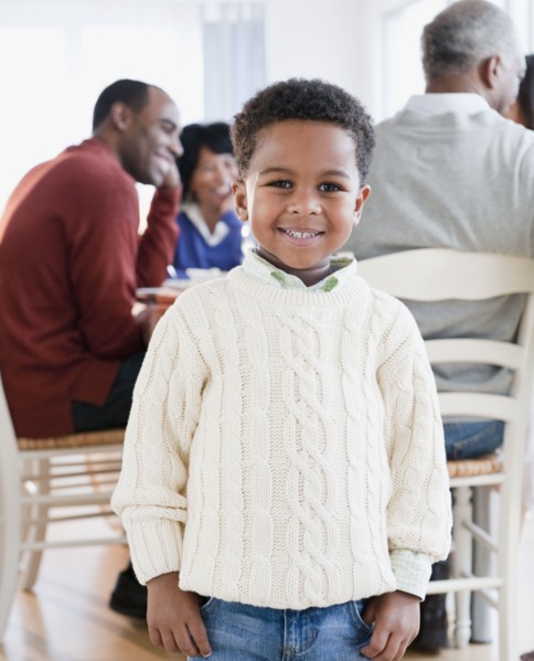 African American boy smiling with family in background