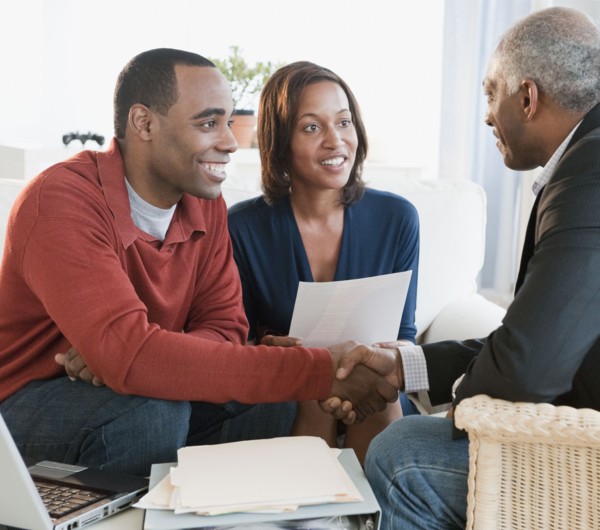 African American couple talking with financial advisor
