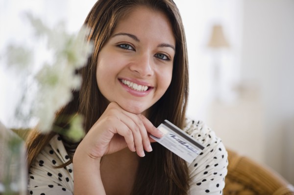 Smiling Indian woman holding credit card