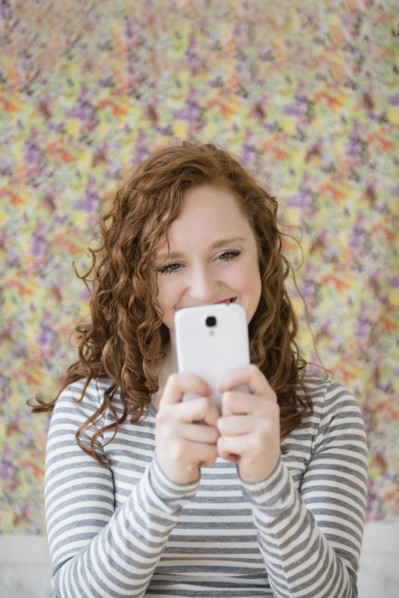 Caucasian woman taking cell phone selfie