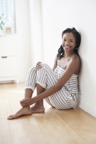 Smiling Black woman sitting on floor