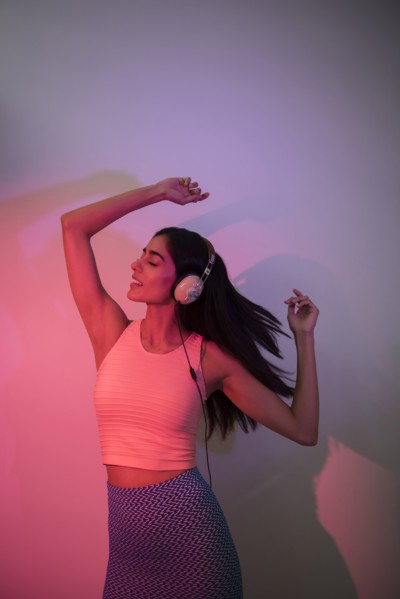 Indian woman dancing near wall casting shadow