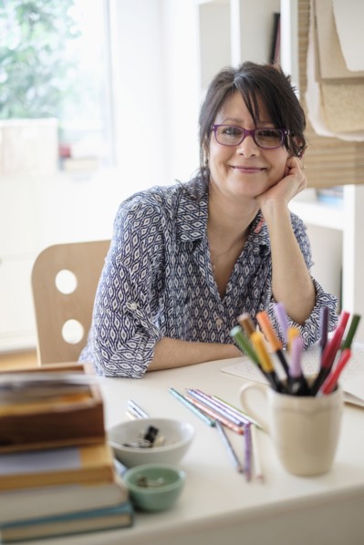 Hispanic woman smiling in home office