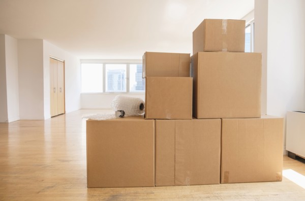 Cardboard boxes and bubble wrap in empty apartment
