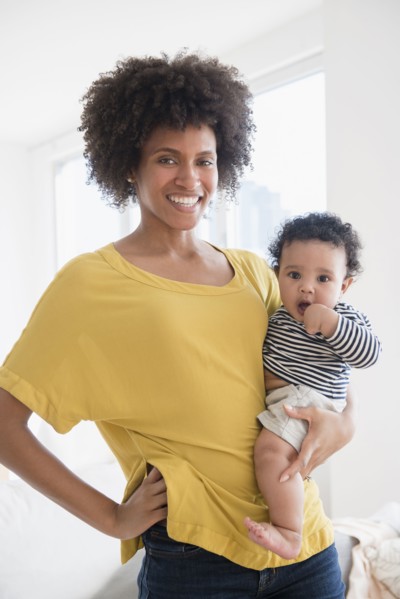 Smiling mother holding baby son