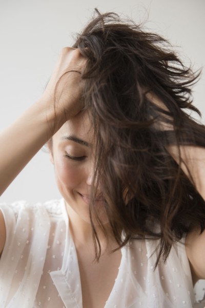 Hispanic woman tossing hair