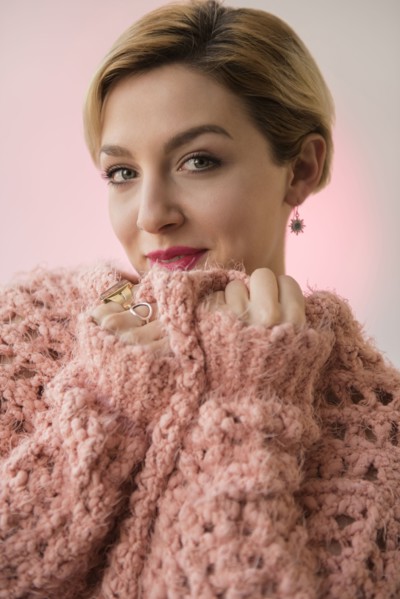Caucasian woman snuggling in pink sweater