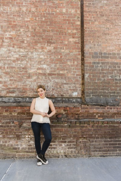 Caucasian woman leaning on brick wall