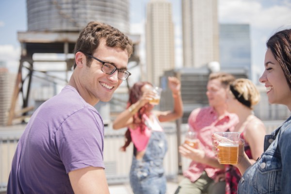 Smiling couple drinking beer outdoors