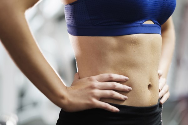 Sweating midriff of Mixed Race woman