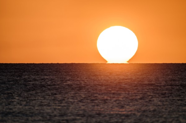 Sunset on horizon of ocean