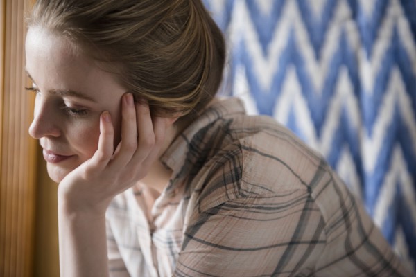Pensive woman with hand on chin