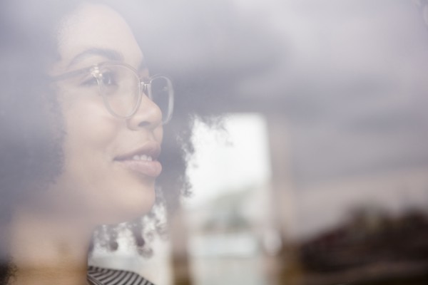 Smiling African American woman behind window