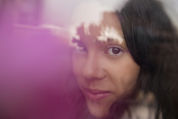 Smiling Hispanic woman behind window