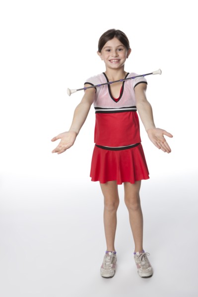 Caucasian girl twirling a baton